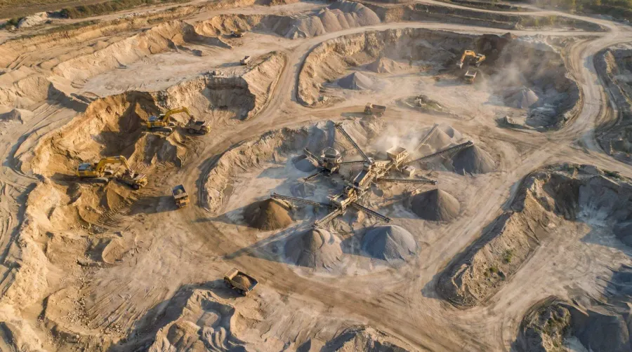 Aerial view of sand and gravel pit operation with heavy machinery