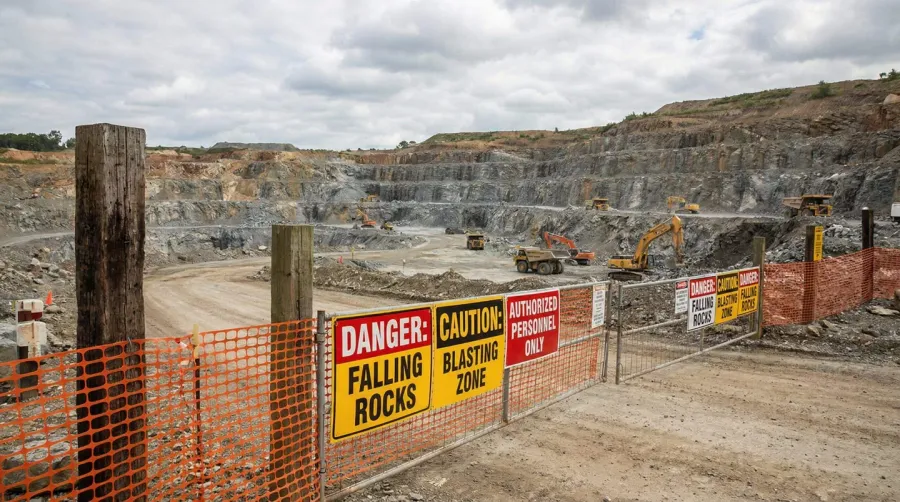 Quarry site with warning signs and safety barriers