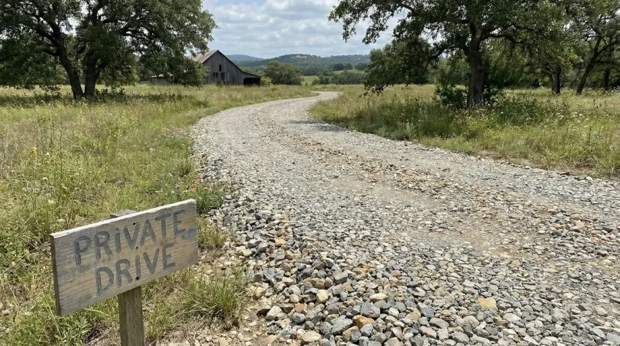rustic crushed concrete driveway with varied aggregate sizes in country setting