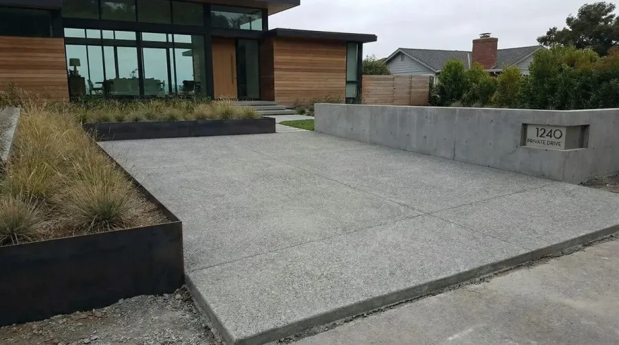 modern crushed concrete driveway with clean lines and gray aggregate texture