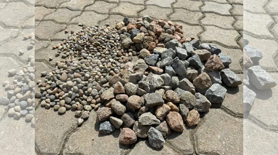 Various sizes of crushed stone displayed on paver surface