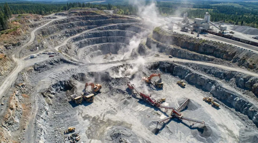 Aerial view of active rock quarry with extraction equipment