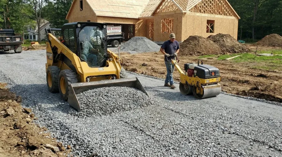 Installation process showing base rock being spread and compacted