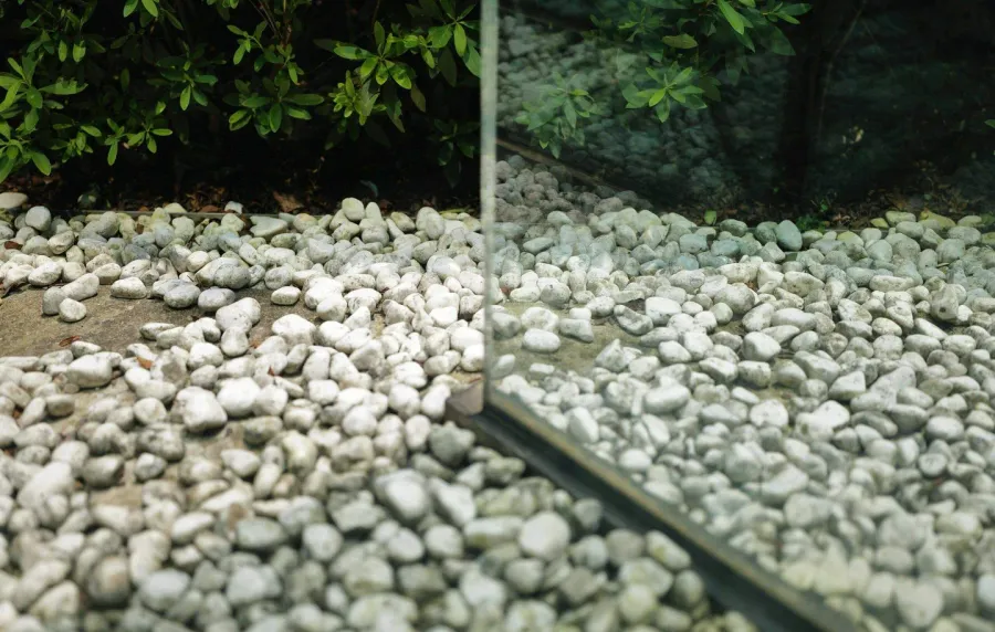 Cross-section diagram showing proper pea gravel installation layers