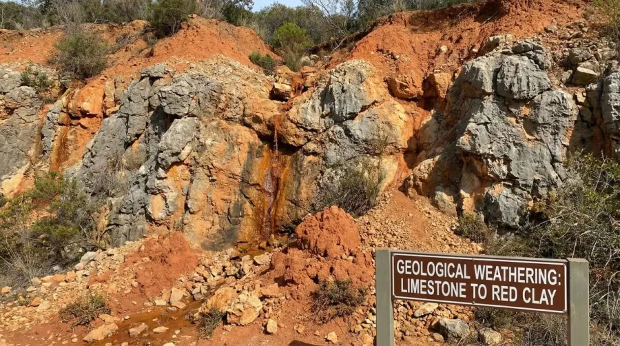 Red clay formation process showing weathered limestone rocks