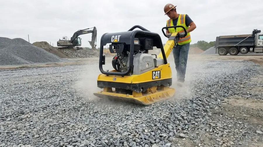Plate Compactor Being Used On Crushed Stone Base
