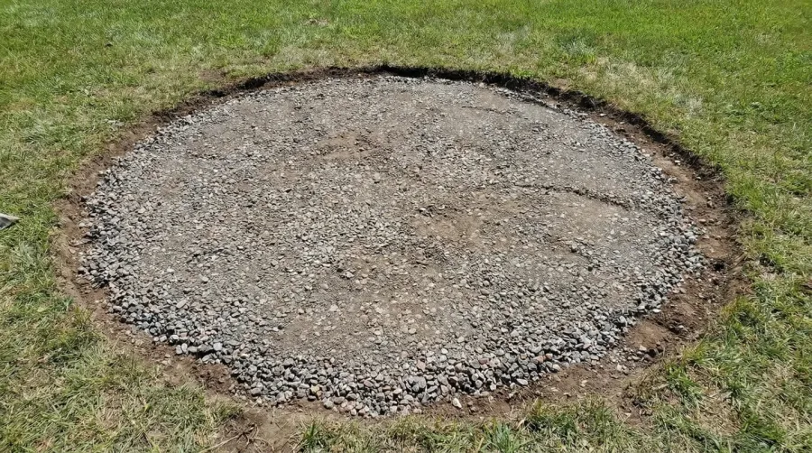 Step-by-step slate installation showing gravel base and proper spacing around fire pit