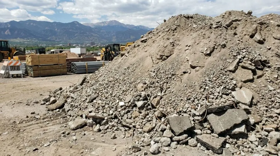 Crushed concrete pile with Colorado Springs mountains in background