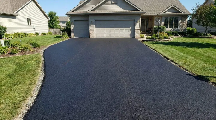Finished driveway with asphalt millings over gravel showing smooth surface