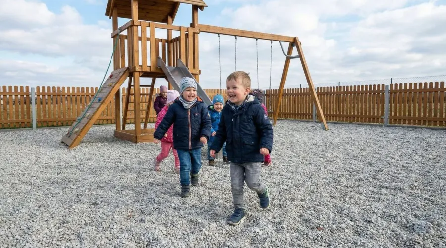 Children playing on limestone playground surface