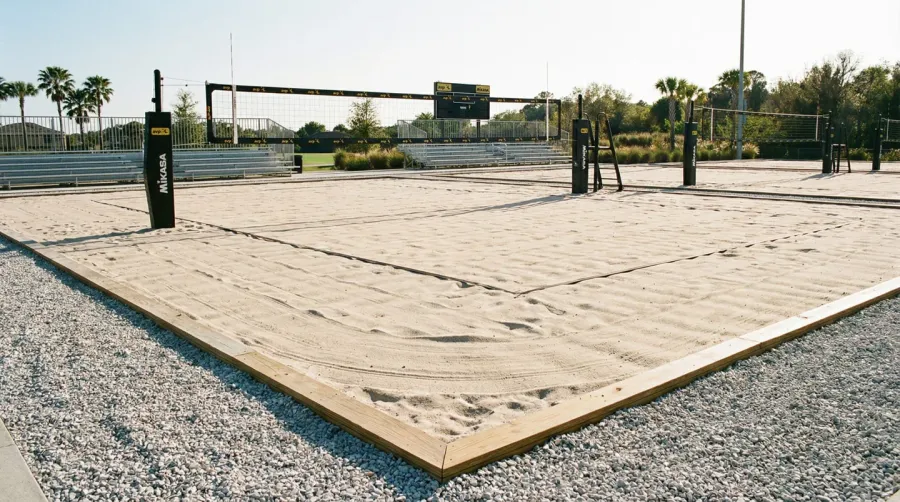 Sand volleyball court with crushed stone border showing clean defined edges
