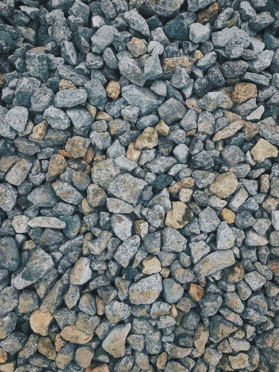 Gravel business startup equipment and materials including dump trucks, loaders, and gravel piles