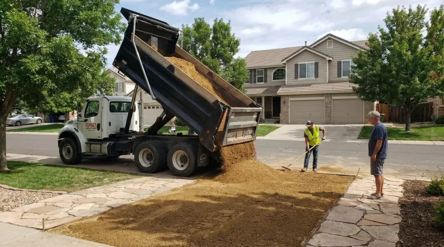 Decomposed granite delivery truck at residential property