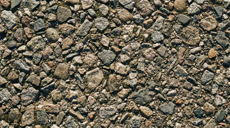 Compacted gravel driveway surface showing stable interlocked stones