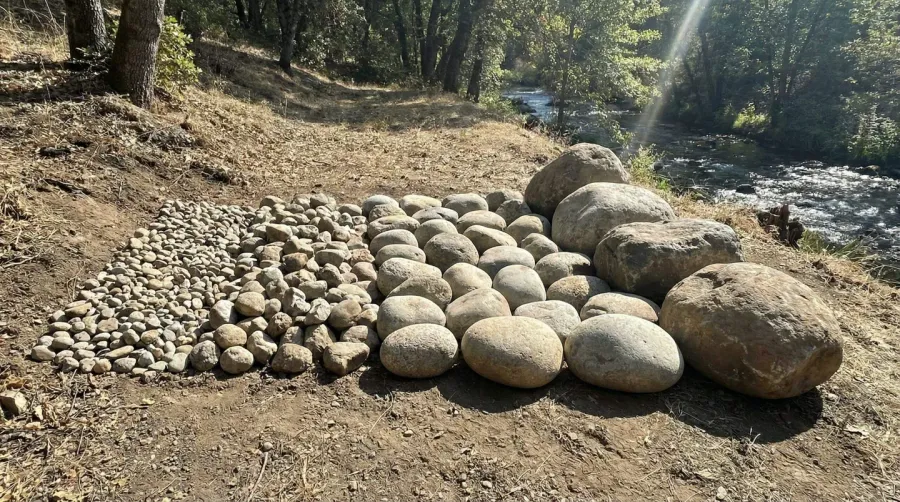 Different river rock sizes arranged by slope steepness