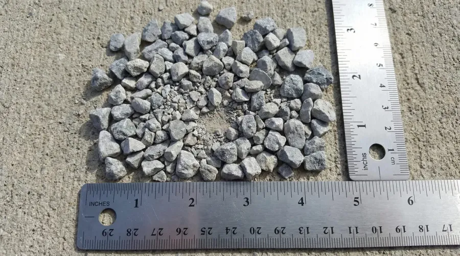 Crushed limestone pieces with ruler showing size measurement