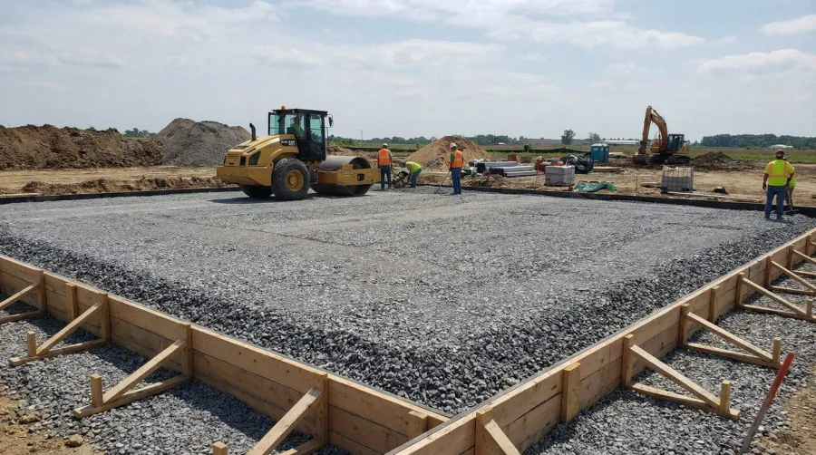 Concrete slab construction process showing stone base layer