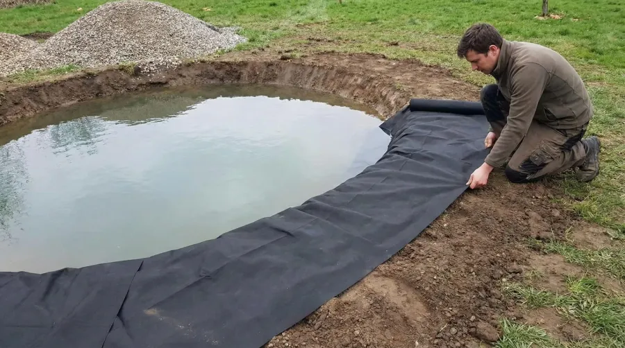 Person installing gravel around pond edge step by step process