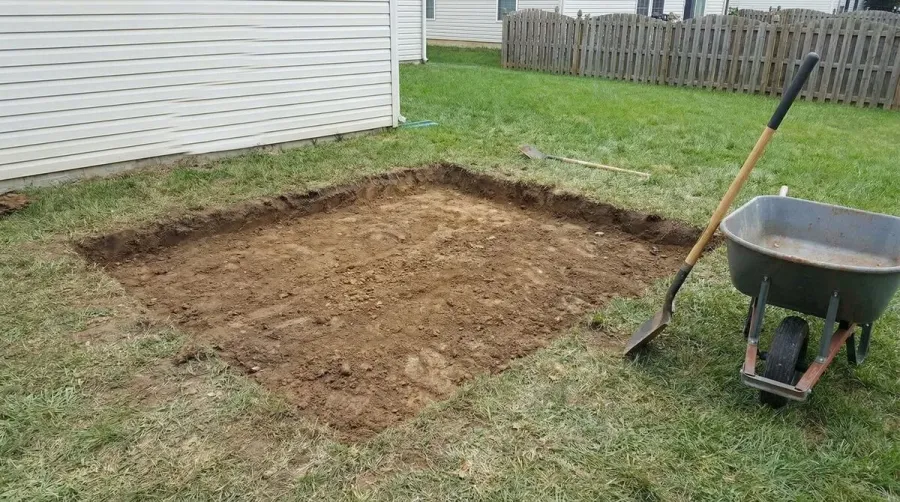 Decomposed granite shed foundation installation process showing layers and compaction