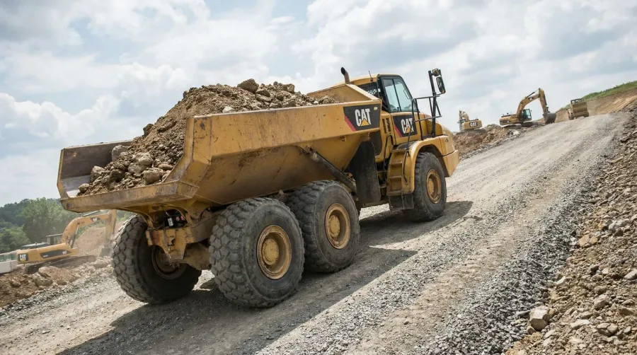 Dump truck climbing steep grade with heavy load