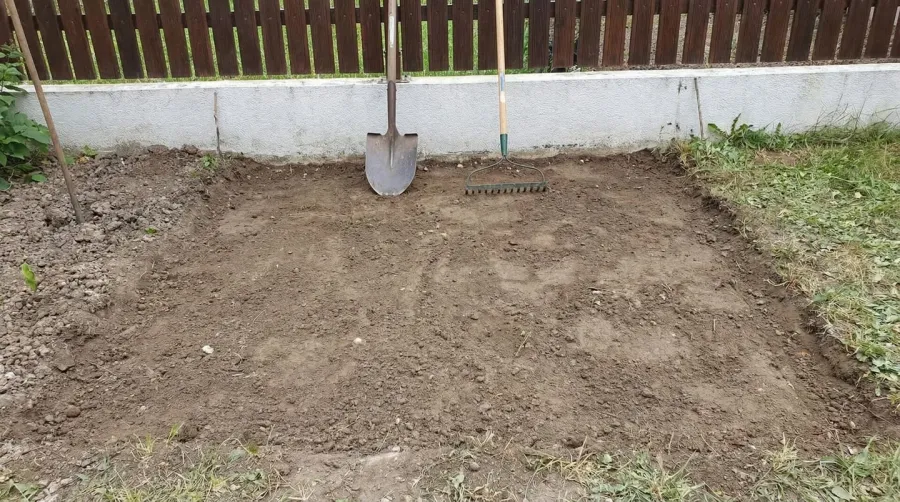 River rock installation process showing landscape fabric and edging