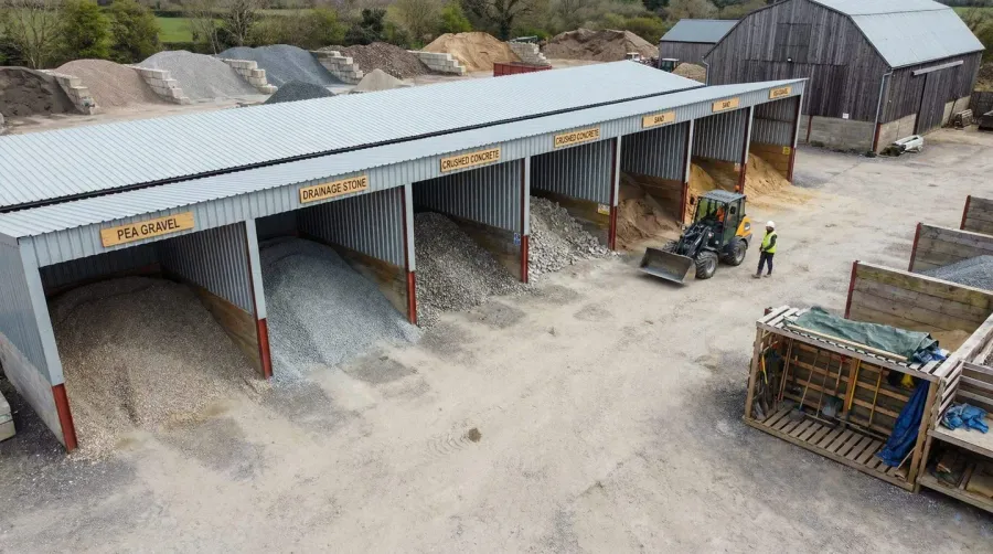 gravel storage setup with covered bins and organized materials