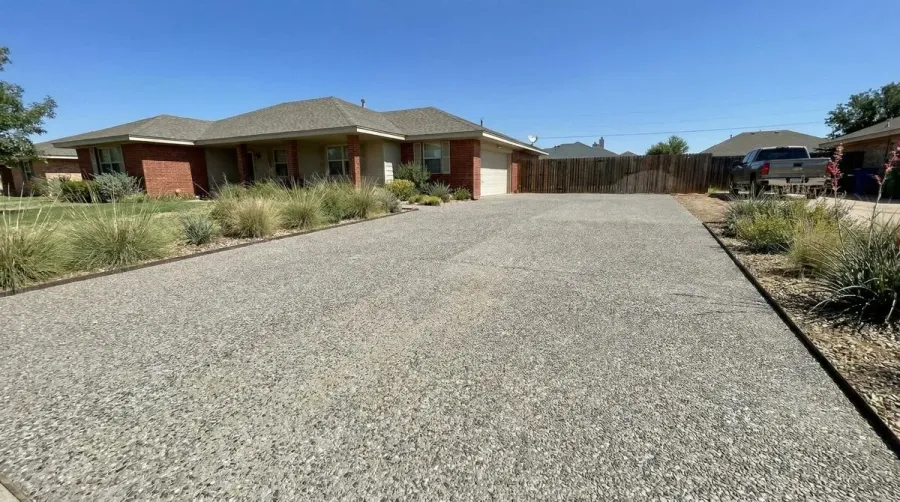 Completed driveway project in Lubbock showing crushed concrete surface with proper grading