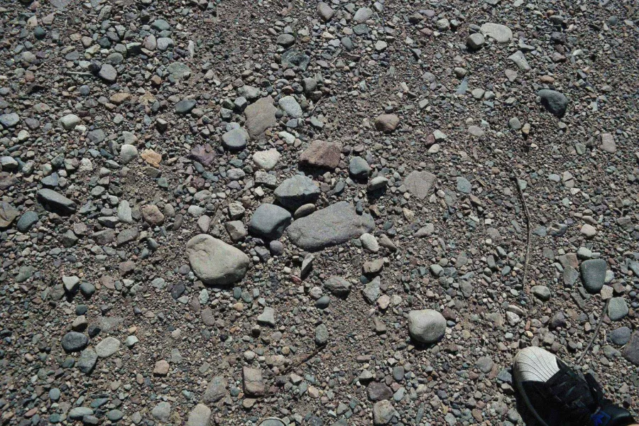 Loose stones scattered on driveway before repair