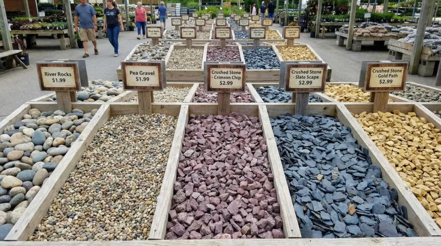 Different types of landscape rocks displayed in organized piles