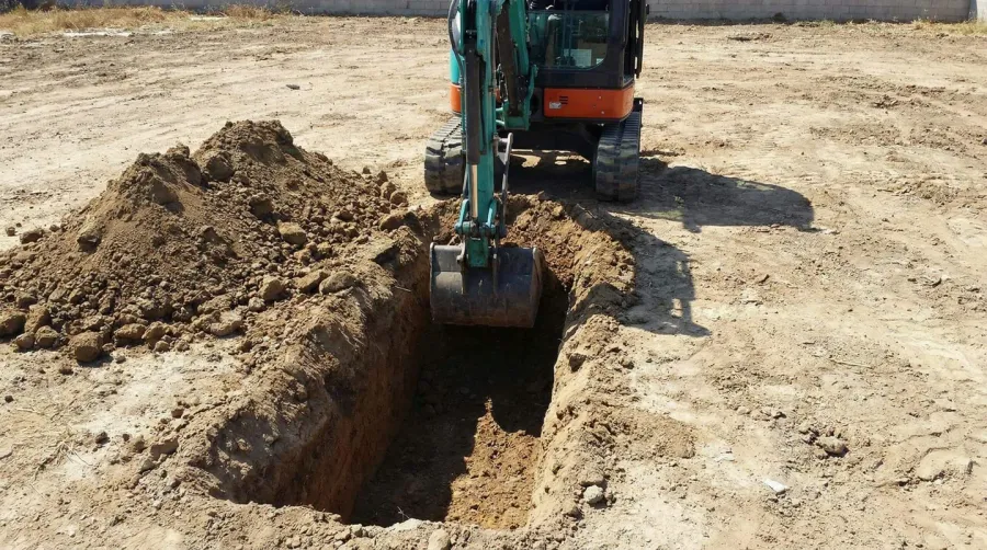 step-by-step installation process showing geotextile fabric placement and gravel application