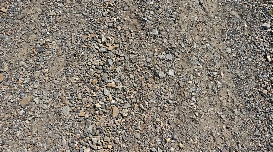 crushed stone bike path surface close up showing angular particles