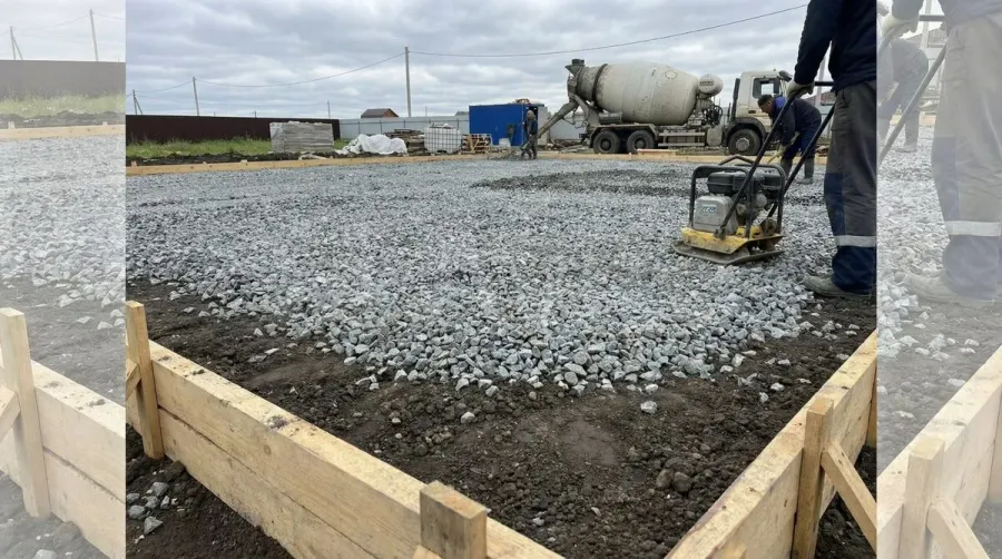 Crushed stone gravel base being installed under concrete slab foundation