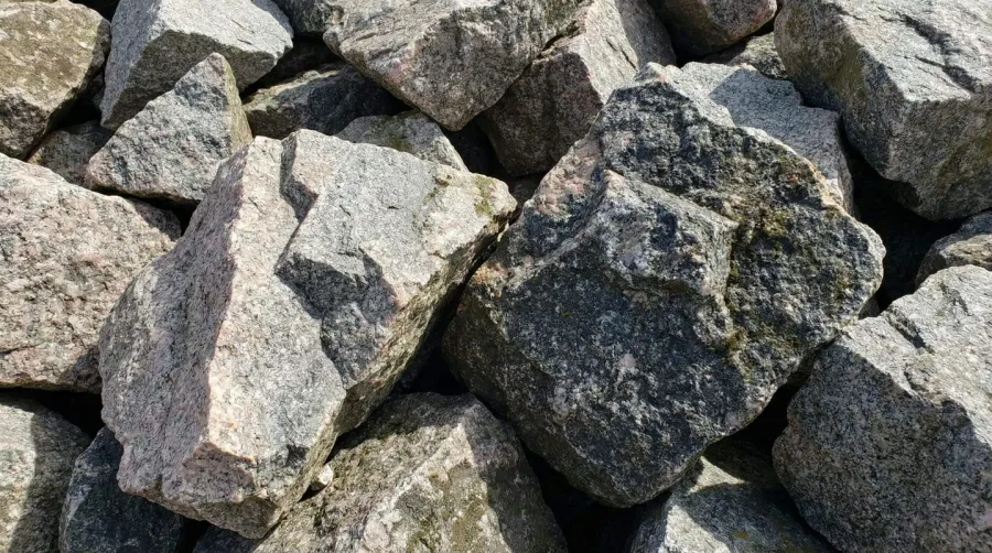 Close-up view of Class II granite rip rap showing angular edges and varied textures