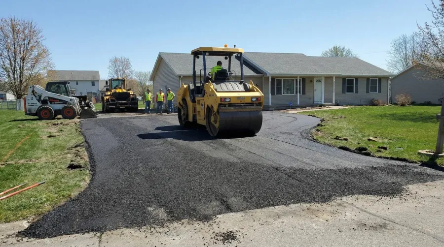 Driveway installation showing millings being compacted