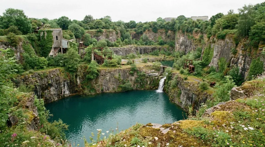 Abandoned Quarry Showing Natural Water Accumulation And Vegetation Growth
