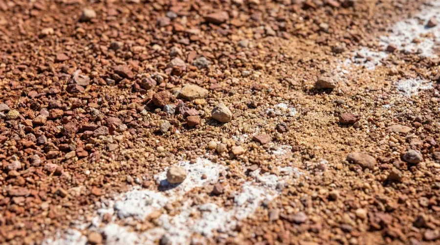 Baseball warning track material showing crushed stone, clay and sand blend