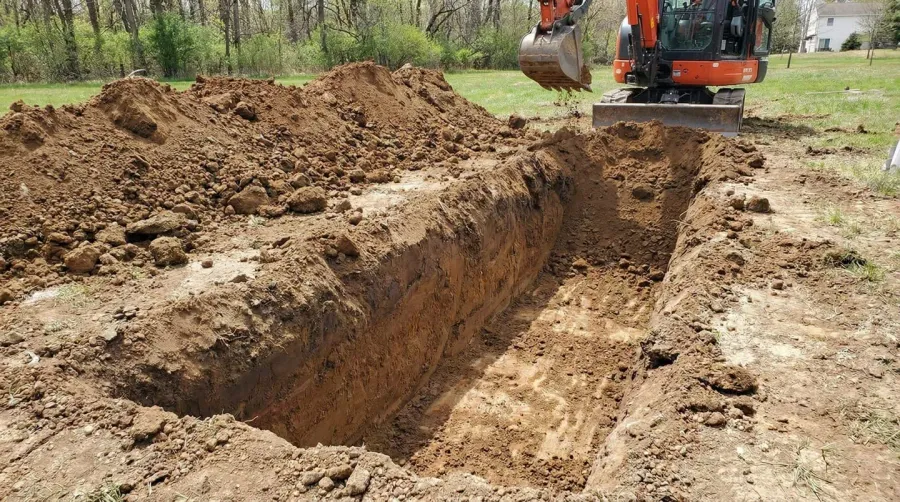 Step-by-step installation photos showing trench digging, fabric placement, gravel layering, and pipe installation