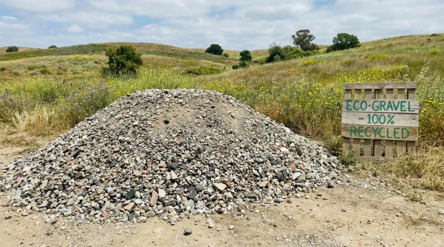 Eco-friendly recycled gravel pile with natural landscape background