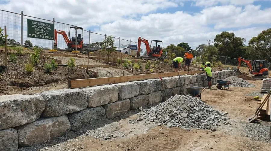 Retaining wall with recycled concrete base construction