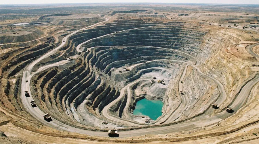 Massive open pit quarry showing depth and scale with mining equipment