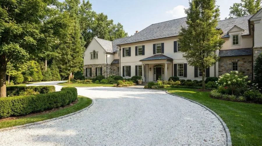 Elegant white gravel driveway in front of home exterior