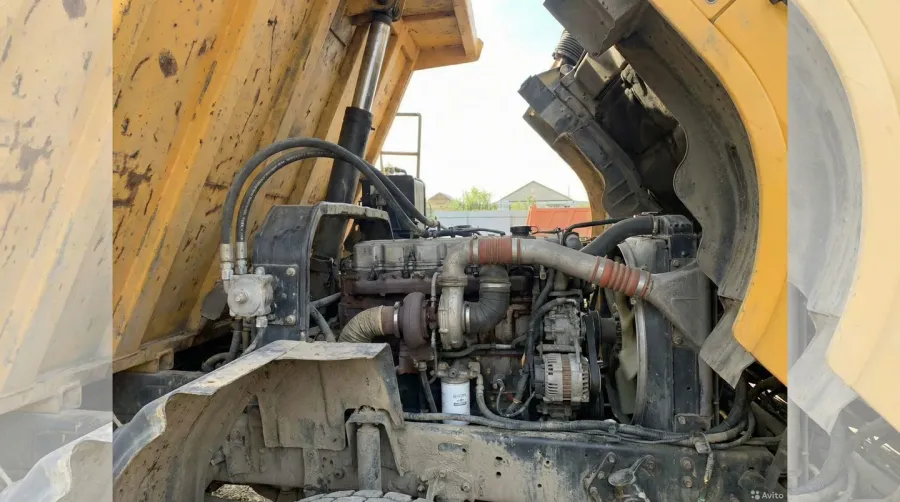 Dump truck engine compartment showing diesel engine